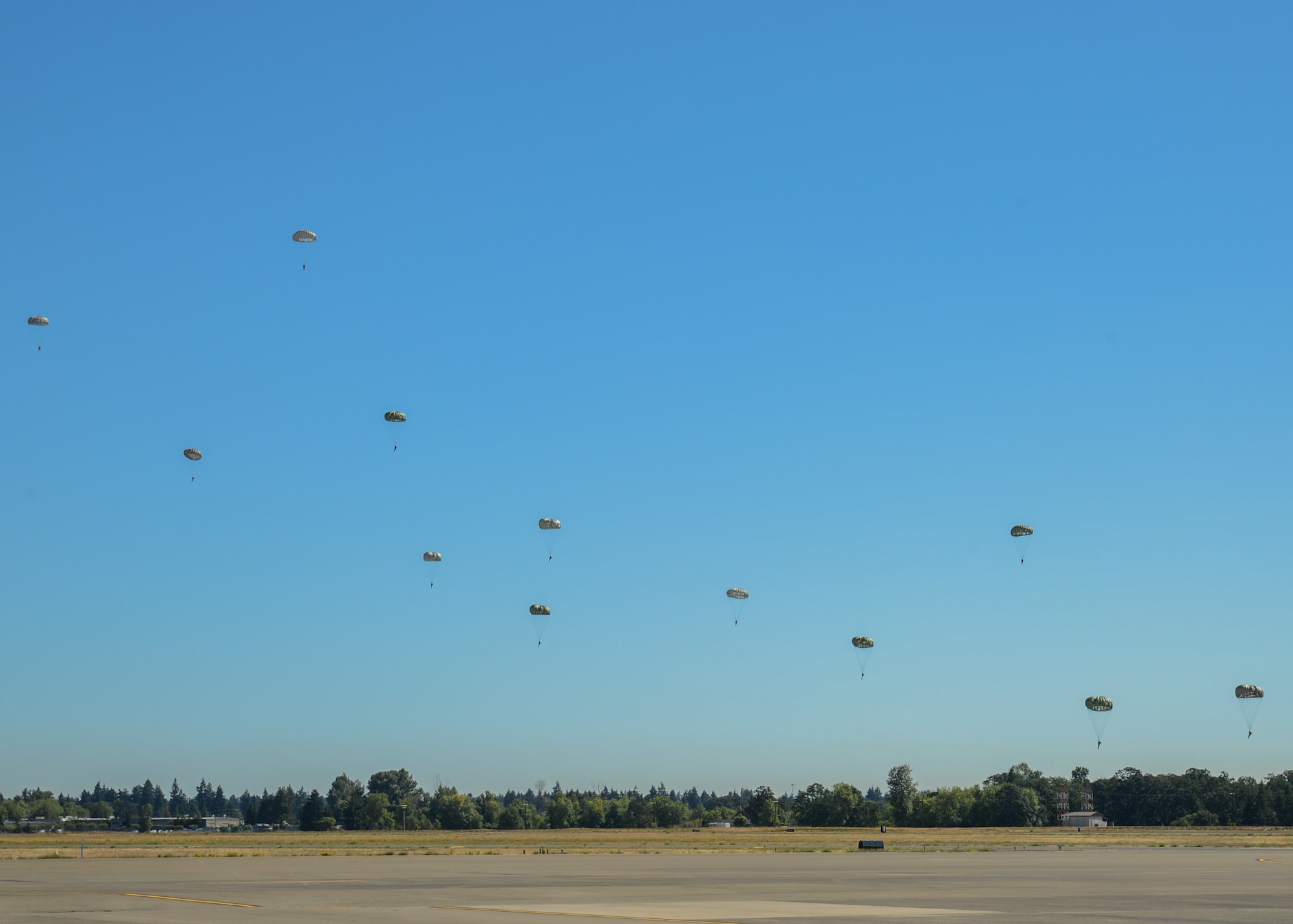 Airborne special operations soldiers with the 3rd Battalion, 1st Special Forces Group jump from a C-17 Globemaster III during a demonstration flight, July 26, 2019, at Joint Base Lewis-McChord, Wash. Team McChord honored the 20th anniversary of the first C-17 delivered to McChord Field, Washington, with a rededication ceremony. (U.S. Air Force photo by Staff Sgt. Joshua Smoot)