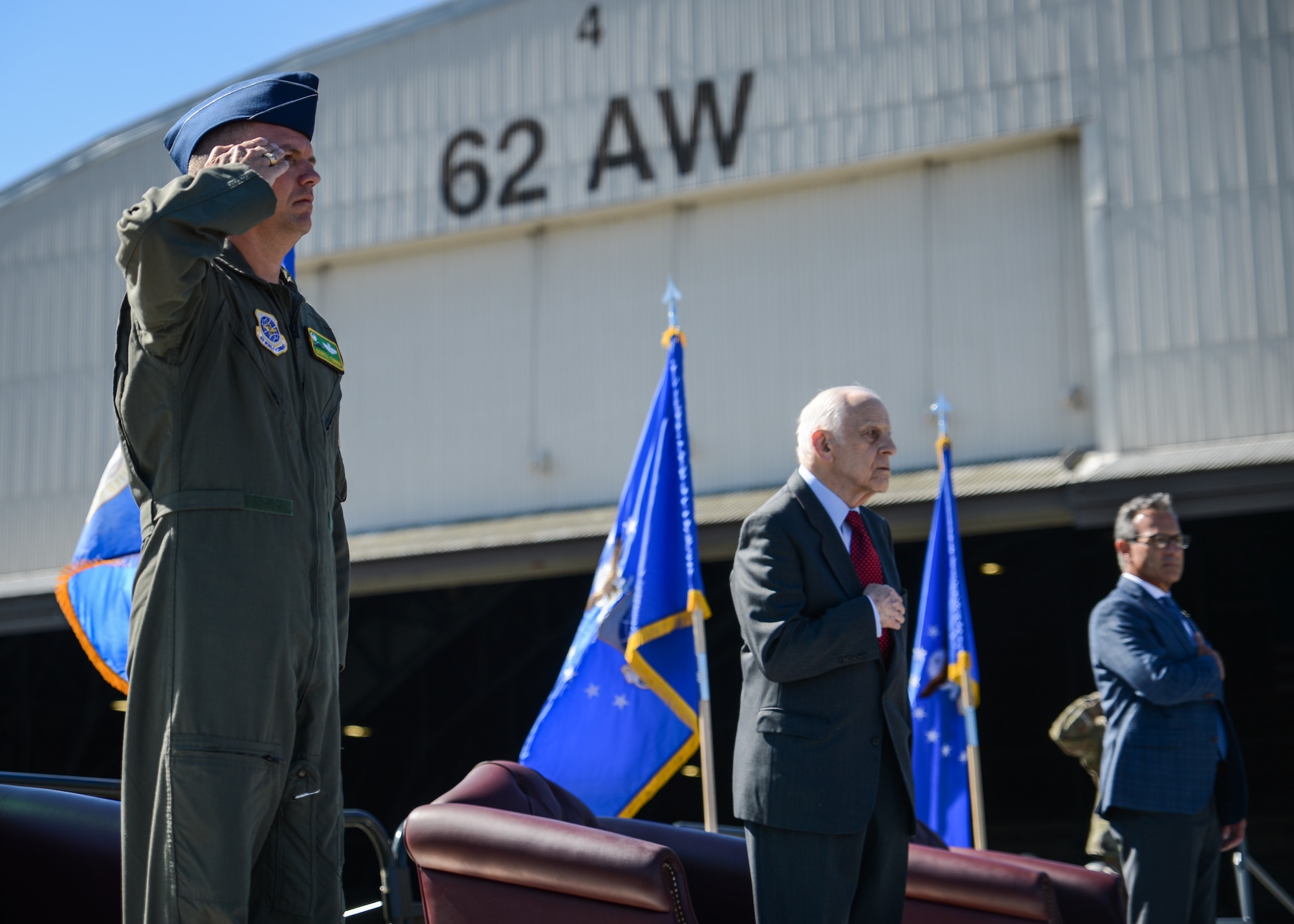 Col Scovill Currin, 62nd Airlift Wing commander, left, Maj Gen Don Brown, ret., and Mark Angello, Vice President of C-17 Services at Boeing Company, right, participate in a rededication ceremony marking the 20th anniversary of C-17 Globemaster IIIs at McChord Field, July 26, 2019, at Joint Base Lewis-McChord, Wash. The first C-17 delivered to McChord is still flying missions at the base today. (U.S. Air Force photo by Staff Sgt. Joshua Smoot)