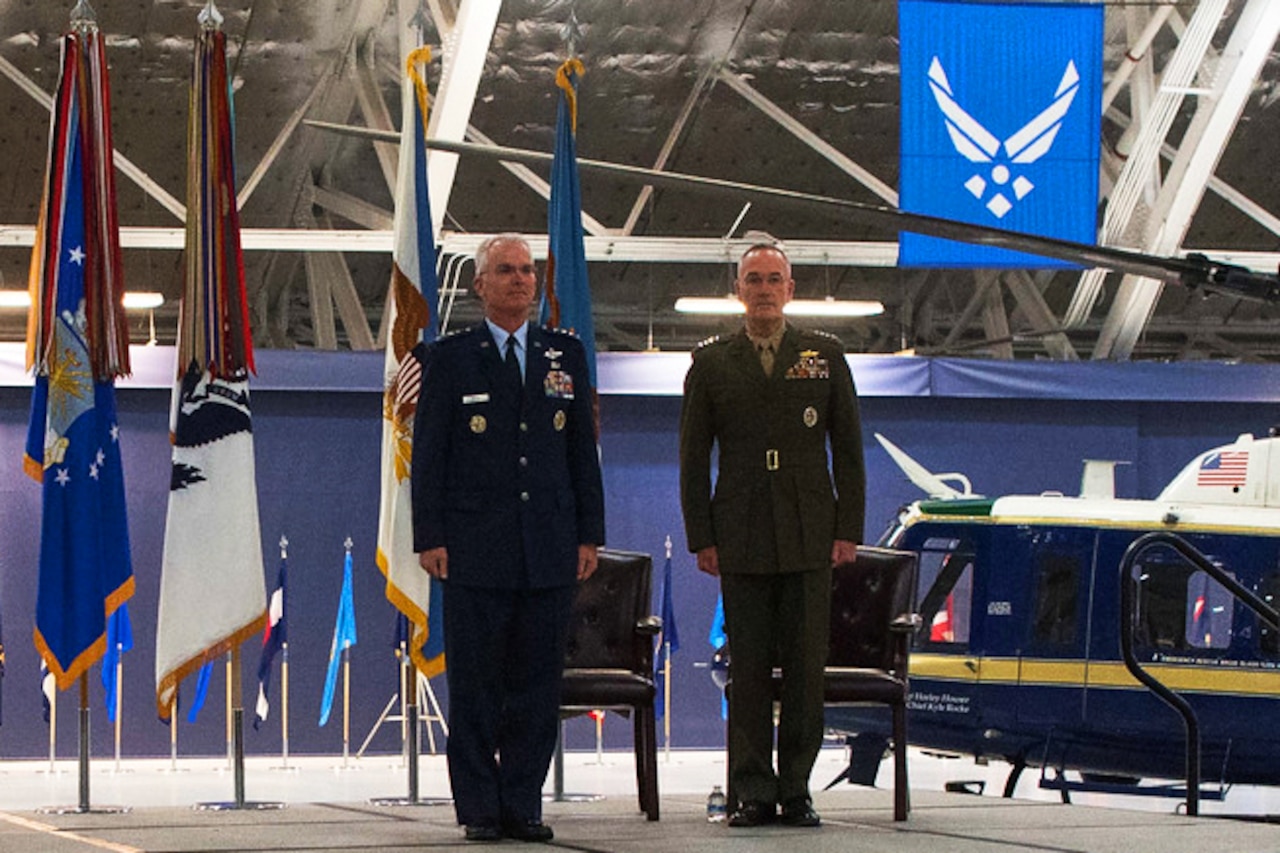 Two men standing.