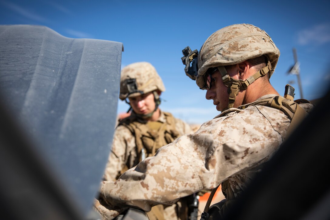A U.S. Marine with 1st Battalion, 25th Marine Regiment, 4th Marine Division, inspects a vehicle at Marine Corps Air Ground Combat Center Twentynine Palms, Calif., July 30, 2019, during Integrated Training Exercise 5-19. ITX 5-19 is an essential component of the Marine Forces Reserve training and readiness cycle. It serves as the principle exercise for assessing a unit’s capabilities. (U.S. Marine Corps photo by Sgt. Andy O. Martinez)