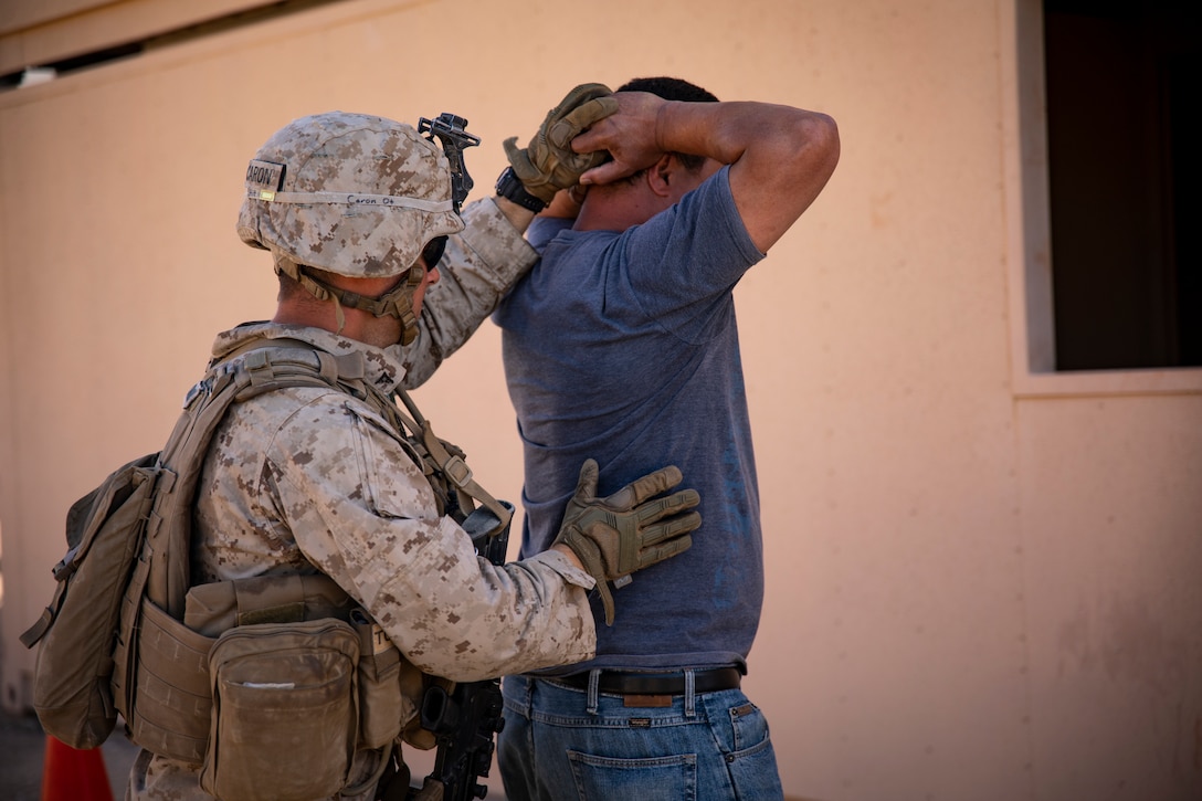 A U.S. Marine with 1st Battalion, 25th Marine Regiment, 4th Marine Division, searches a detainee at Marine Corps Air Ground Combat Center Twentynine Palms, Calif., July 30, 2019, during Integrated Training Exercise 5-19. ITX 5-19 is an essential component of the Marine Forces Reserve training and readiness cycle. It serves as the principle exercise for assessing a unit’s capabilities. (U.S. Marine Corps photo by Sgt. Andy O. Martinez)