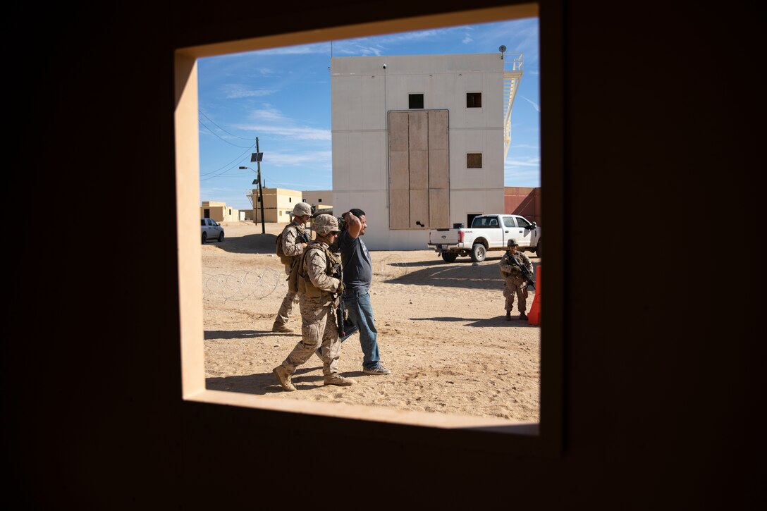 A U.S. Marine with 1st Battalion, 25th Marine Regiment, 4th Marine Division, escorts a detainee at Marine Corps Air Ground Combat Center Twentynine Palms, Calif., July 30, 2019, during Integrated Training Exercise 5-19. ITX 5-19 is an essential component of the Marine Forces Reserve training and readiness cycle. It serves as the principle exercise for assessing a unit’s capabilities. (U.S. Marine Corps photo by Sgt. Andy O. Martinez)