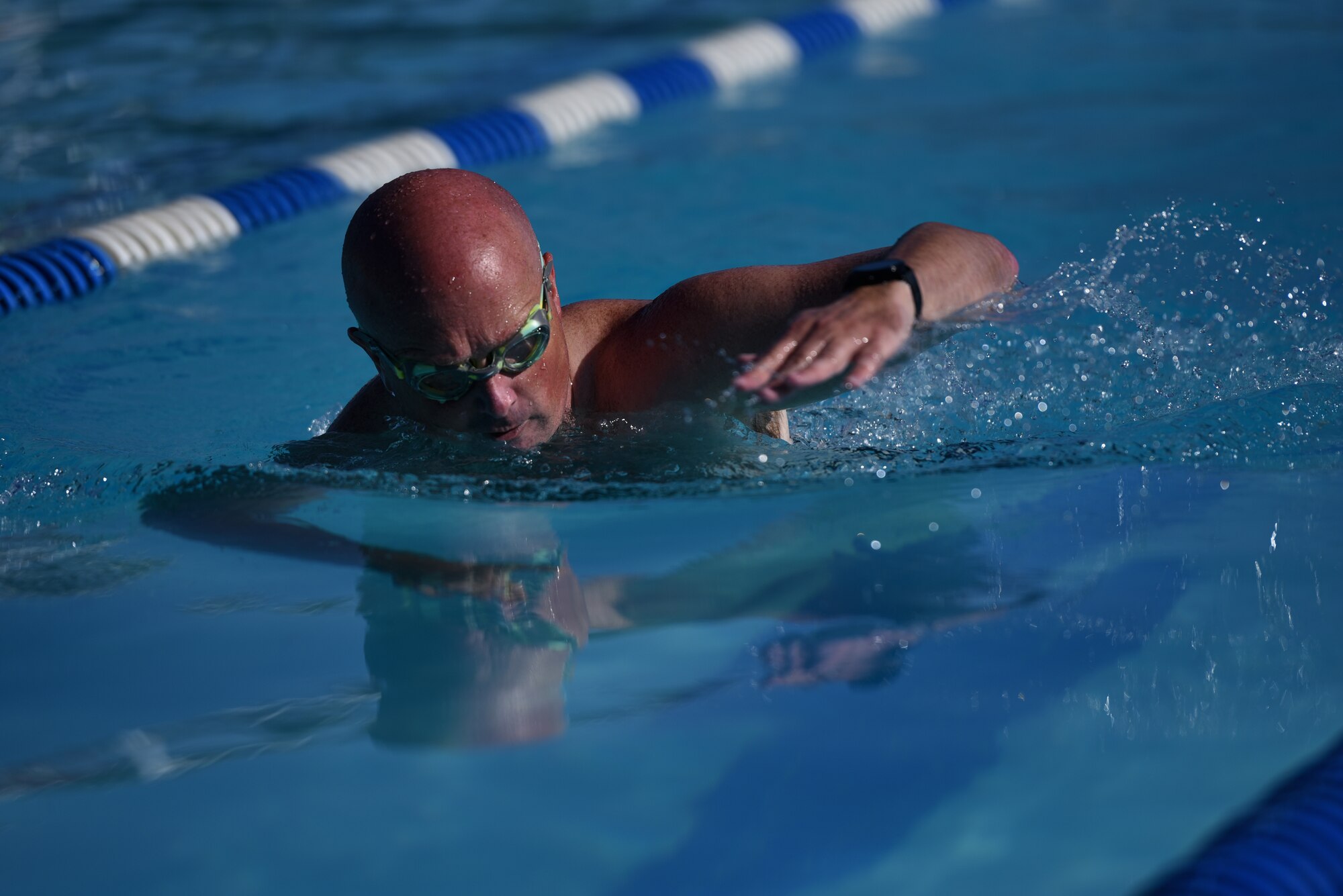 U.S. Air Force Maj. Joshua Reno, 860th Aircraft Maintenance Squadron commander, swims during the first leg of the Travis Triathlon July 27, 2019, at Travis Air Force Base, California. During the triathlon, which is in its 26th year, 31 athletes competed against one another. Participants had to swim 400 meters, bike 12 miles and run 3.1 miles. (U.S. Air Force Photo by Airman 1st Class Cameron Otte)