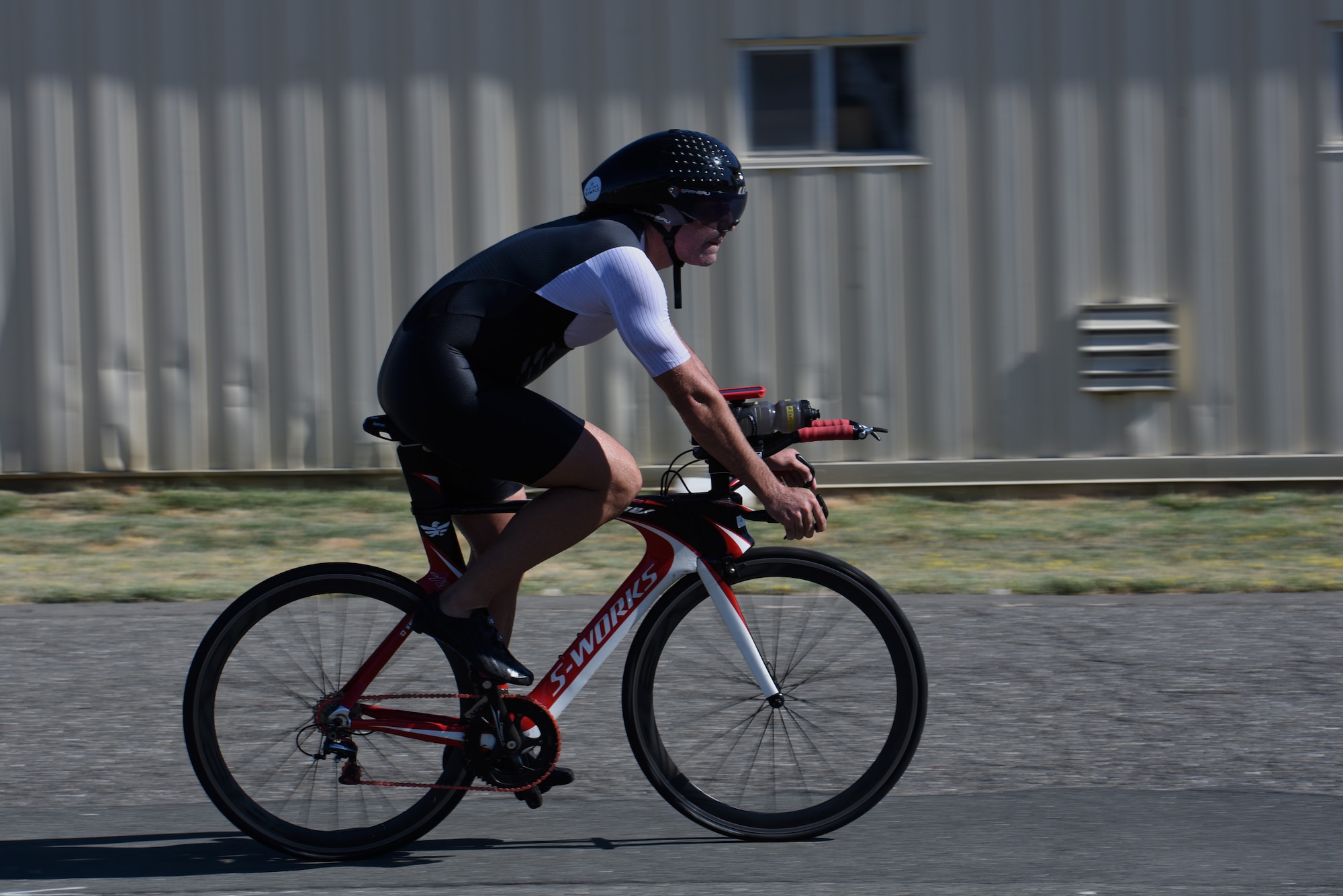 William Nichols, 60th Operations Support Squadron, rides a bike during the second leg of the Travis Triathlon July 27, 2019, at Travis Air Force Base, California. During the triathlon, which is in its 26th year, 31 athletes competed against one another. Participants had to swim 400 meters, bike 12 miles and run 3.1 miles. (U.S. Air Force Photo by Airman 1st Class Cameron Otte)