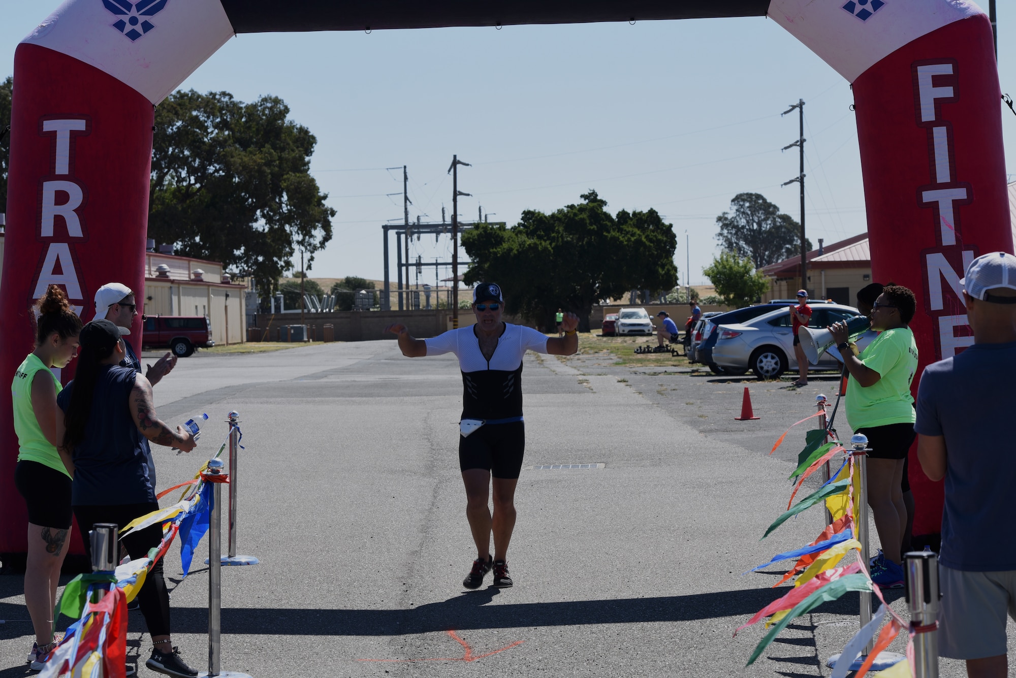 William Nichols, 60th Operations Support Squadron, crosses the finish line of the Travis Triathlon July 27, 2019, at Travis Air Force Base, California. During the triathlon, which is in its 26th year, 31 athletes competed against one another. Participants had to swim 400 meters, bike 12 miles and run 3.1 miles. (U.S. Air Force Photo by Airman 1st Class Cameron Otte)