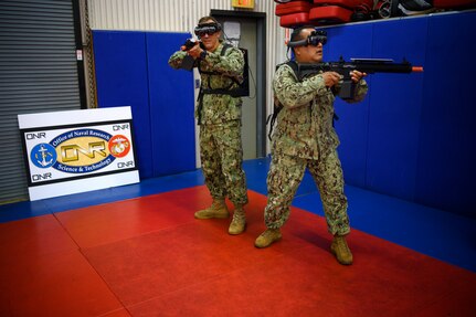 IMAGE: 190613-N-PO203-0122 CHESAPEAKE, Virginia (Jun. 13, 2019) Sailors assigned to the Center for Security Forces detachment in Chesapeake, Va., demonstrate the Office of Naval Research Global (ONRG) TechSolutions-sponsored Tactically Reconfigurable Artificial Combat Enhanced Reality (TRACER) system. TechSolutions partnered with Naval Surface Warfare Center Dahlgren Division to develop the TRACER package, which consists of a virtual-reality headset, a backpack, a state-of-the-art simulated weapon designed to deliver realistic recoil, and a software package that creates multiple and adaptable simulation scenarios for security personnel to experience. ONRG TechSolutions allows Sailors and Marines to submit technology requests directly to the development community for rapid response prototyping. (U.S. Navy photo by John F. Williams)