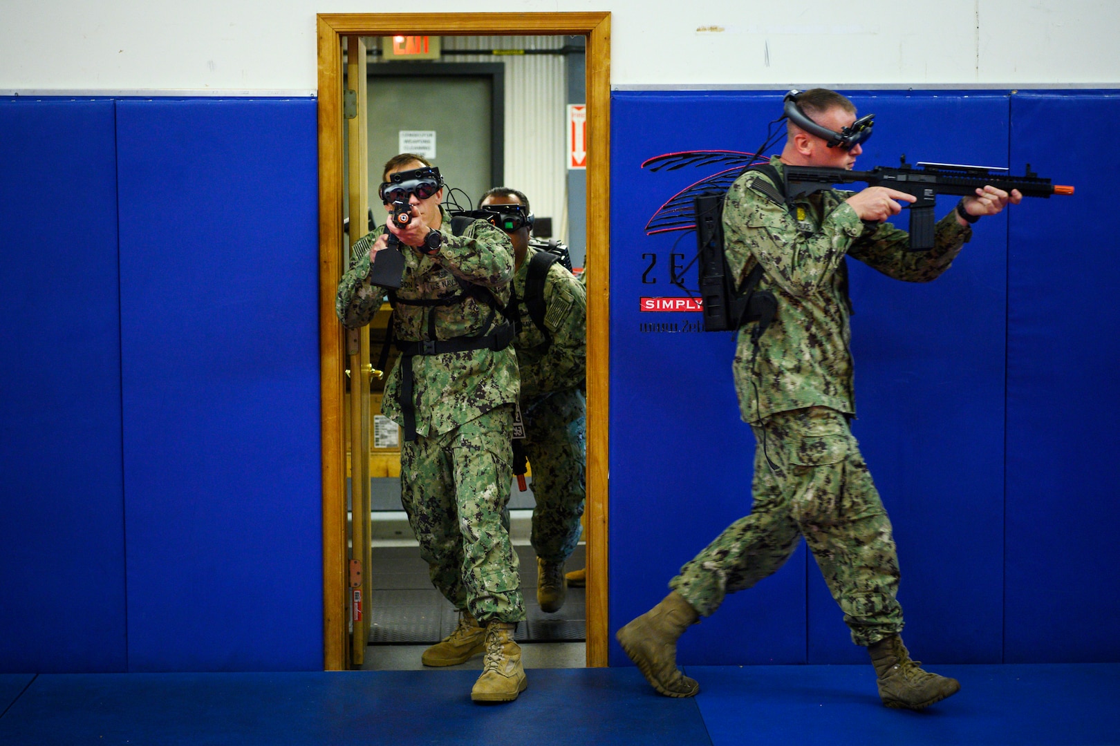 IMAGE: 190613-N-PO203-0147 CHESAPEAKE, Virginia (Jun. 13, 2019) Sailors assigned to the Center for Security Forces detachment in Chesapeake, Va., demonstrate the Office of Naval Research Global (ONRG) TechSolutions-sponsored Tactically Reconfigurable Artificial Combat Enhanced Reality (TRACER) system. TechSolutions partnered with Naval Surface Warfare Center Dahlgren Division to develop the TRACER package, which consists of a virtual-reality headset, a backpack, a state-of-the-art simulated weapon designed to deliver realistic recoil, and a software package that creates multiple and adaptable simulation scenarios for security personnel to experience. ONRG TechSolutions allows Sailors and Marines to submit technology requests directly to the development community for rapid response prototyping. (U.S. Navy photo by John F. Williams)