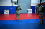 IMAGE: 190613-N-PO203-0186 CHESAPEAKE, Virginia (Jun. 13, 2019) Sailors assigned to the Center for Security Forces detachment in Chesapeake, Va., demonstrate the Office of Naval Research Global (ONRG) TechSolutions-sponsored Tactically Reconfigurable Artificial Combat Enhanced Reality (TRACER) system. TechSolutions partnered with Naval Surface Warfare Center Dahlgren Division to develop the TRACER package, which consists of a virtual-reality headset, a backpack, a state-of-the-art simulated weapon designed to deliver realistic recoil, and a software package that creates multiple and adaptable simulation scenarios for security personnel to experience. ONRG TechSolutions allows Sailors and Marines to submit technology requests directly to the development community for rapid response prototyping. (U.S. Navy photo by John F. Williams)