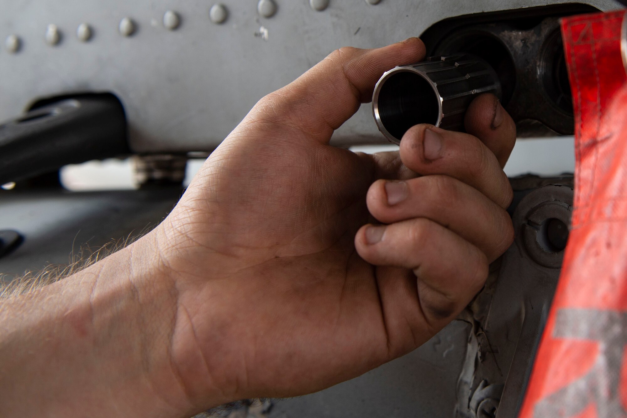 Senior Airman Steven Shelp, left, 75th Aircraft Maintenance Unit weapons load crew member, prepares an A-10C Thunderbolt II for the upload of a munition during an integrated combat training, July 26, 2019, at Moody Air Force Base, Ga. The integrated combat training involved Airmen from several specialties who worked simultaneously to refuel and upload munitions on to an A-10. The training also allowed Airmen to gain experience quick-turning an aircraft, which helped increase their readiness in support of contingency operations. (U.S. Air Force photo by Airman Azaria E. Foster)