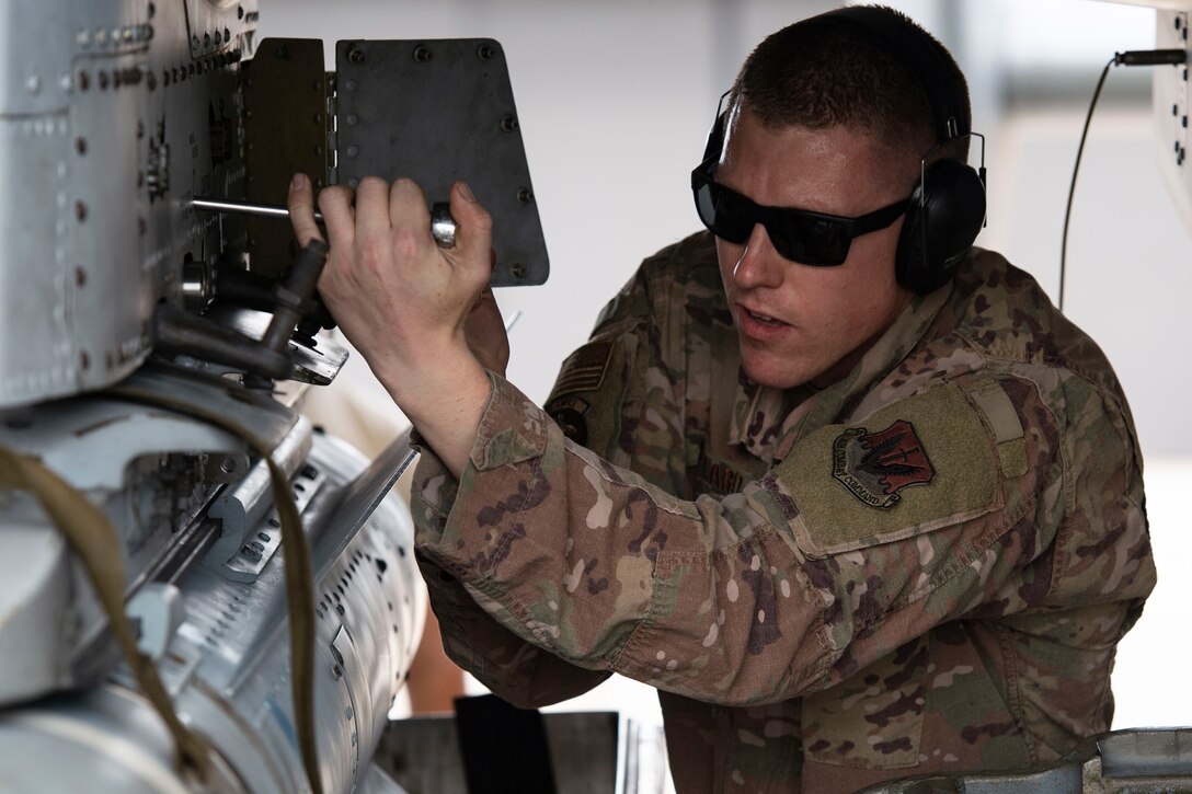 Staff Sgt. Michael Hillard, 75th AMU weapons load crew chief, secures a munition during integrated combat training, July 26, 2019, at Moody Air Force Base, Ga. The integrated combat training involved Airmen from several specialties who worked simultaneously to refuel and upload munitions on to an A-10C Thunderbolt II. The training also allowed Airmen to gain experience quick-turning an aircraft, which helped increase their readiness in support of contingency operations. (U.S. Air Force photo by Airman Azaria E. Foster)