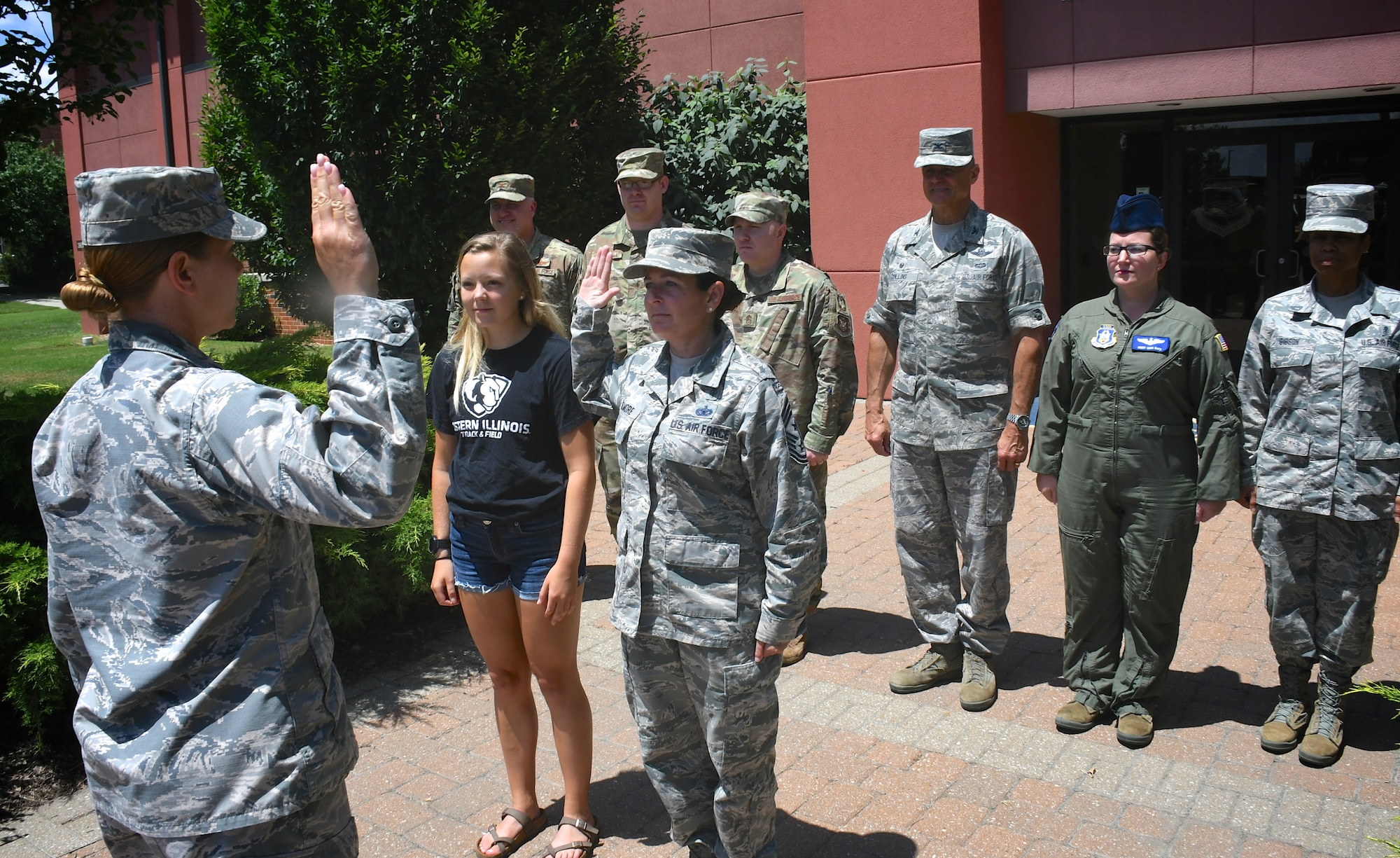 The highest ranking enlisted member of the 932nd Airlift Wing, Command Chief Master Sgt. Barbara Gilmore (third from left), reenlists with the oath performed by 1st Lt. Sheri Mason-Rogier, 932nd Mission Support Group executive officer, on July 14, 2019, at Scott Air Force Base, Ill.  (U.S. Air Force photo by Lt. Col. Stan Paregien)