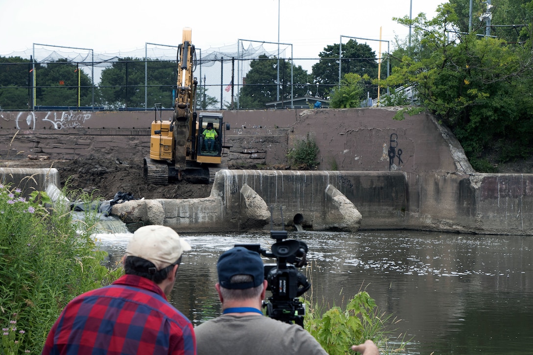 A camera crew from WTTW in Chicago records as demolition begins on the North Branch Dam in River Park July 31, 2018. The four-foot high concrete dam at the convergence of the North Branch of the Chicago River and the North Shore Channel on Chicago’s north side was a barrier to healthy ecosystems and was removed by the U.S. Army Corps of Engineers Chicago District in 2018. (U.S. Army photo by Beth Concepcion/Released)
