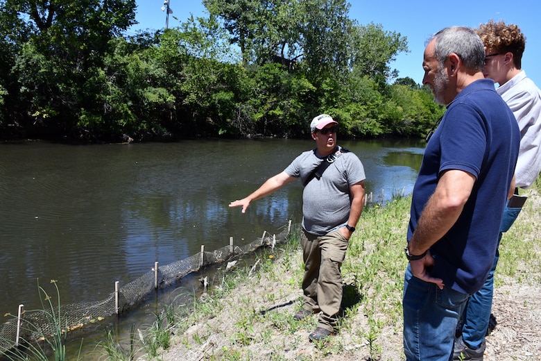 Jason Zylka, (left), U.S. Army Corps of Engineers Chicago District ecologist, explains to Mike Padilla (front), an engineer with the Chicago District, and Aiden Kelly, university student, the importance of the Chicago River natural riparian habitat in River Park July 31, 2019. The four-foot high concrete dam at the convergence of the North Branch of the Chicago River and the North Shore Channel on Chicago’s north side was a barrier to healthy ecosystems and was removed by the Chicago District in 2018. (U.S. Army photo by Mariah Oliveras/Released)