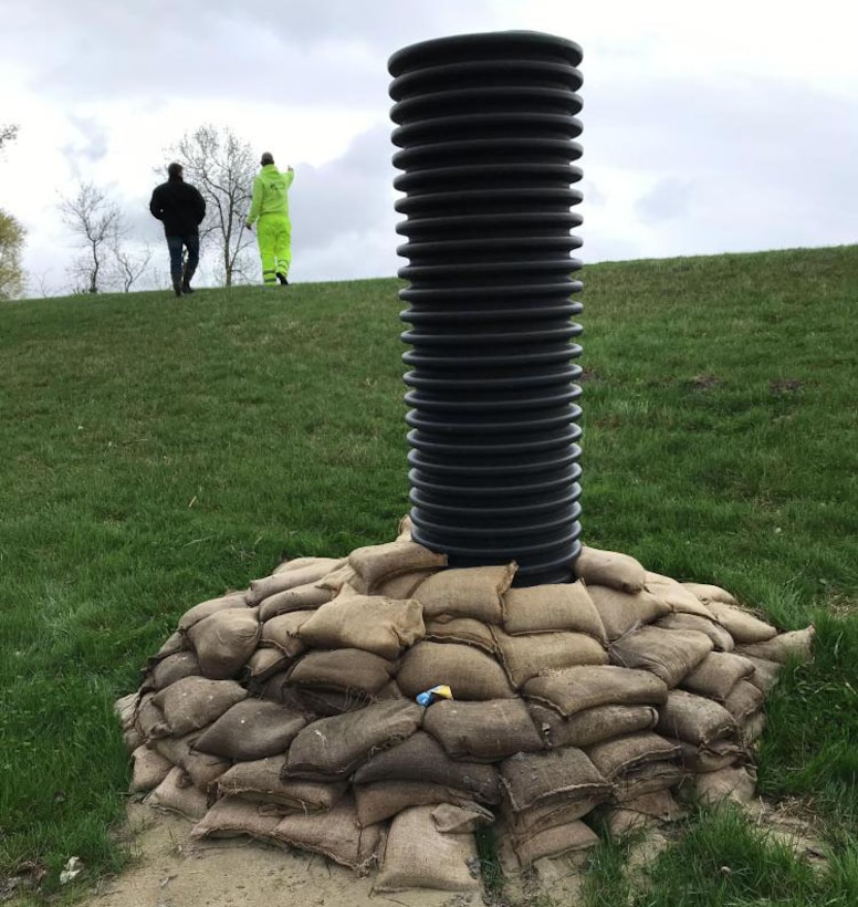 Locals used sandbags and pipe to protect against a large sand boil in the levee. Photo taken Apr. 25, 2019.