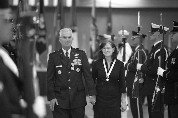 Gen. Paul Selva and his wife, Ricki, hold hands.