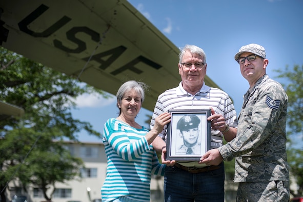 Jan Whitmore, left, a John Brown University fitness instructor, Eugene Whitmore, center, a United Natural Food Incorporate sales manager, and Tech. Sgt. Tyler Whitmore, right, the 35th Maintenance Group Air Force repair enhancement program manager, holds a photo of 1st David C. Clements in Risner Circle at Misawa Air Base, Japan, May 30, 2019. Clements, a 468th Strategic Fighter Squadron fighter pilot, passed away April 16, 1953, at 27 years, from an aircraft ejection malfunction. In his honor, his name is painted on the F-86F Sabre static display behind his family in this picture. (U.S. Air Force photo by Senior Airman Collette Brooks)