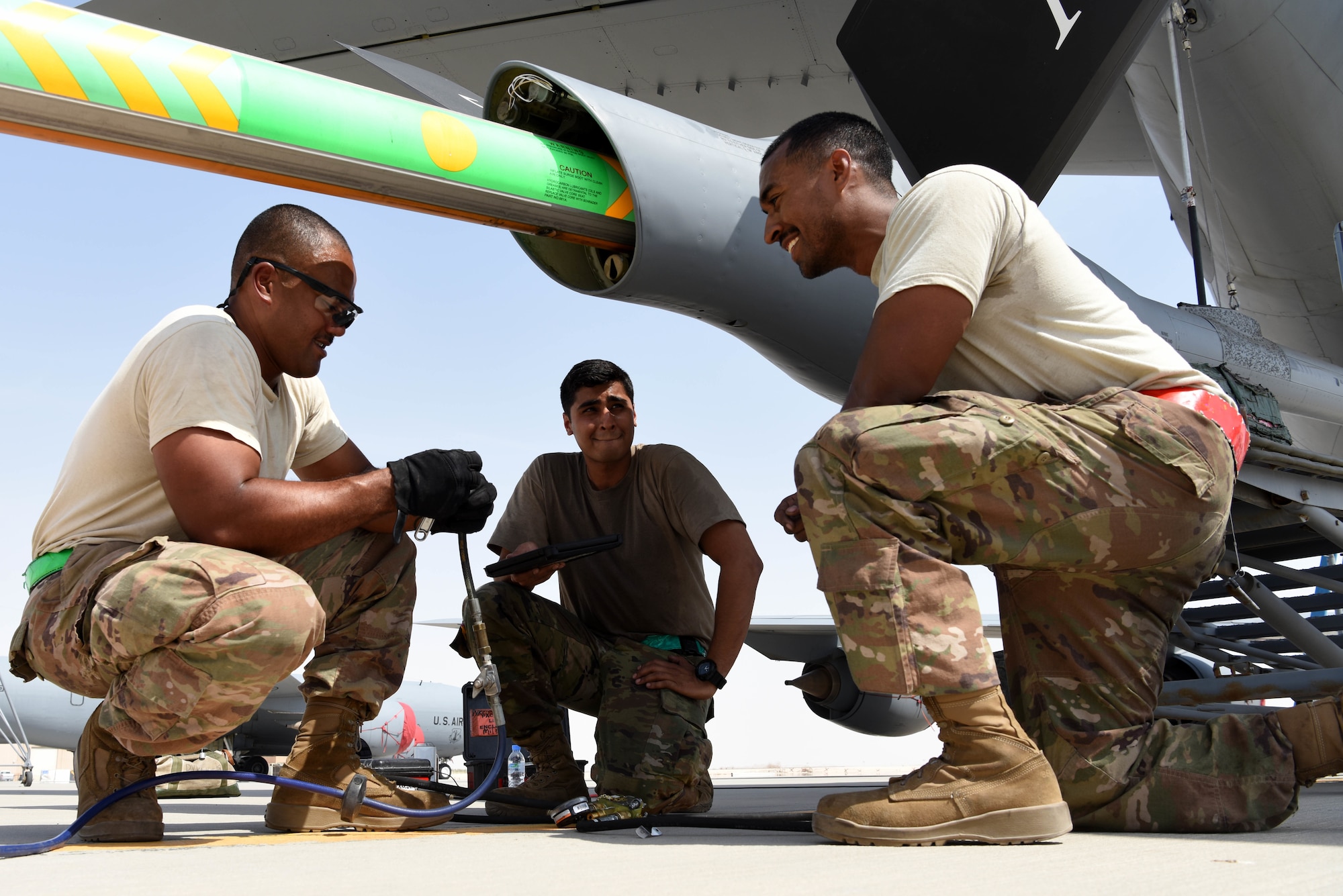 385th Expeditionary Aircraft Maintenance Squadron crew chiefs perform routine maintenance on an aircraft at Al Udeid AB, Qatar, June 1, 2019. The 385th AEG is the only group in Air Mobility Command capable of redeploying anywhere around the world. The group provides Air Force Central Command with the ability to provide and deliver combat resources to the warfighter. (U.S. Air Force photo by Staff Sgt. Ashley L. Gardner)