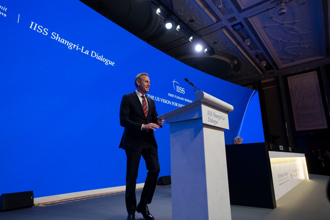 The acting secretary of defense approaches a lectern.