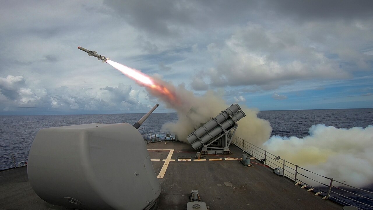 A missile launches off the deck of a military vessel.