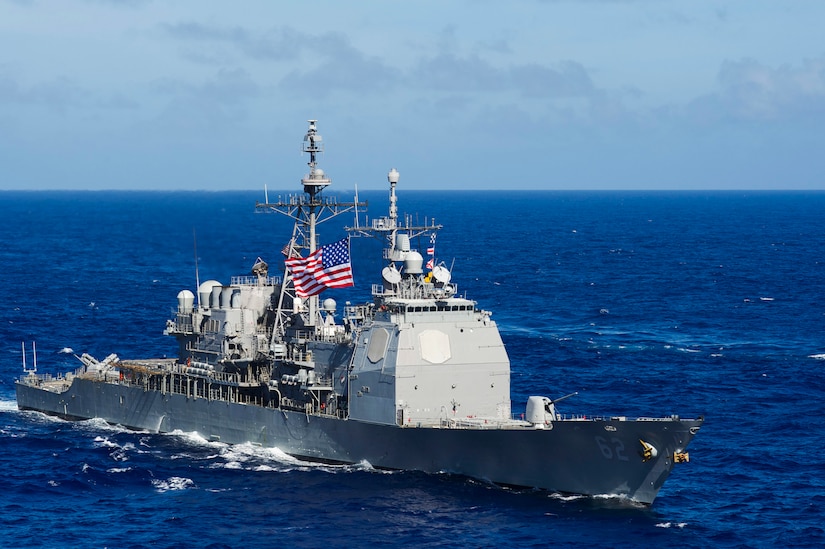 A military ship cruises the ocean.