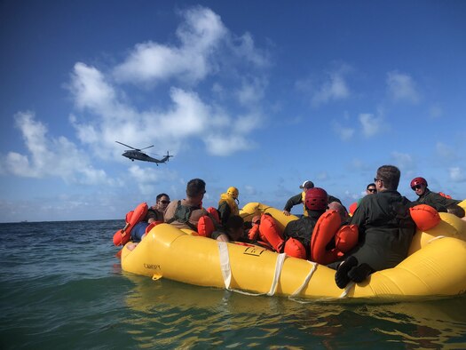 Reserve Citizen Airmen from Joint Base Charleston's 315th Airlift Wing participate in a water survival training event held at Naval Air Station Key West, Fl., May 31, 2019. Airmen were taken by boat into open water, far from shore where a MH-60 Seahawk helicopter hoisted them individually out of the water using a rescue basket. (U.S. Air Force photo by Senior Airman William Brugge)