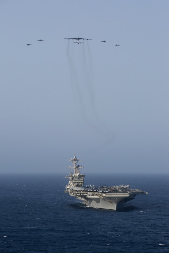 A photo of B-52 and Abraham Lincoln Carrier Strike Group.