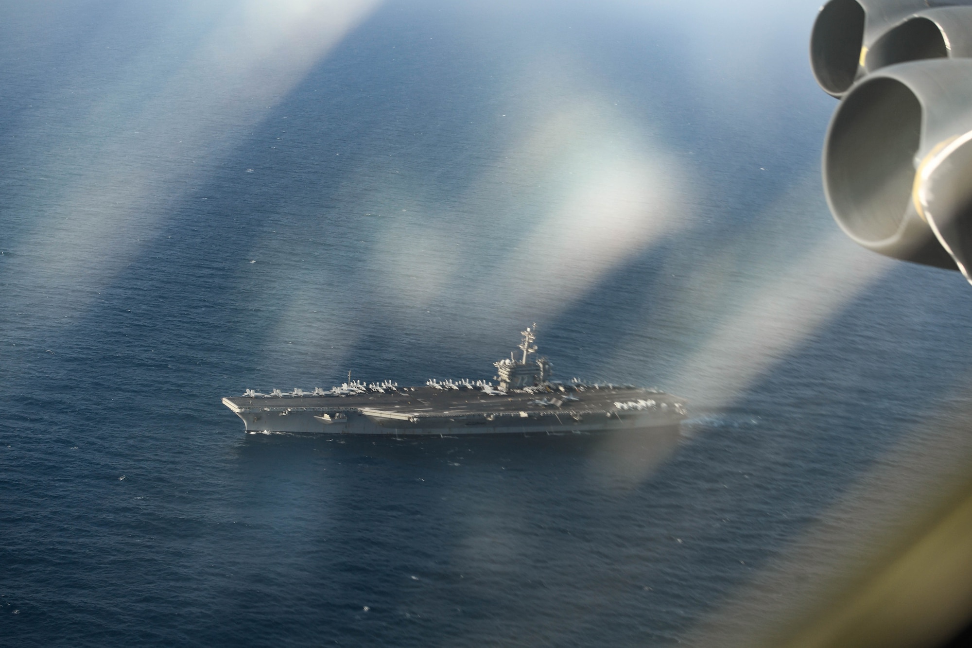 A photo of USS Abraham Lincoln taken from a B-52 in air.