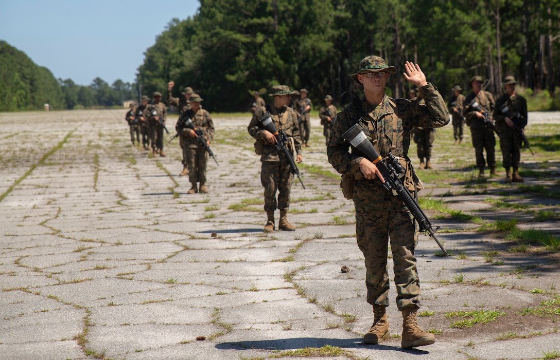 U.S. Marine Corps recruits with Mike Company, 3rd Recruit Training Batallion, practice various hand-and-arm signals on a simulated patrol during Basic Warrior Training at Paige Field on Parris Island, S.C., May 15, 2019. BWT is a week-long training event that teaches recruits the basics of combat survival and advanced rifle manuevers. (U.S. Marine Corps photo by Cpl. Daniel O'Sullivan)