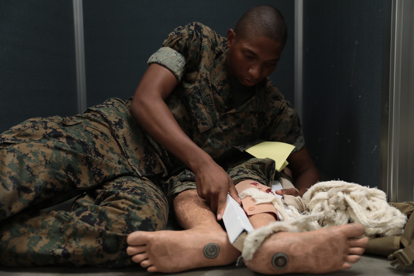 A U.S. Marine Corps Recruit with Mike Company, 3rd Recruit Training Battalion, performs combat casualty care on the final practical application aboard Marine Corps Recruit Depot Parris Island, S.C., May 28, 2019. Within the course of recruit training, recruits learn how to conduct combat casualty care, troop formations, casualty carries, as well as hand and arm signals. (U.S. Marine Corps photo by Cpl. Andrew Neumann/Released)