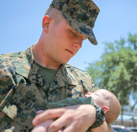 Pvt. Hunter Willmon, a Scottsboro, Ala. native, held his son for the first time on Family Day, May 26. Willmon graduated today from recruit training.