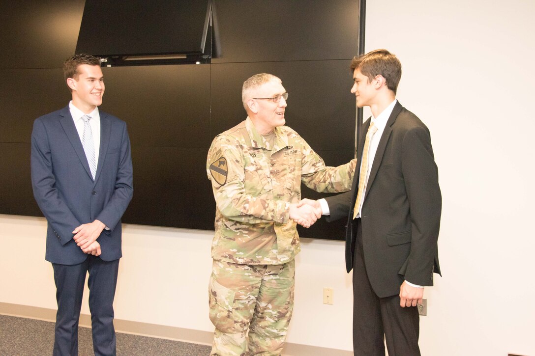 Colonel Stephen Bales, Middle East District Commander, congratulates Derek Sprincis and  Matthew Flacksenburg on the successful completion of their high school engineering and project management internships.  The Middle East District’s high school intern program is dedicated to sparking an interest in U.S. Army Corps of Engineers positions for future generations of bright and driven individuals with an interest in STEM and/or project management.