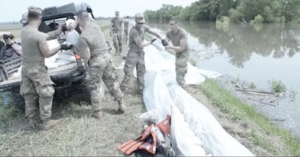 A team of Soldiers of the 2nd Battalion, 123 Field Artillery Regiment, work on levees near Winchester, Illinois, on June 1, 2019. Hundreds of Illinois Guard Soldiers are on state active duty assisting with flood control.