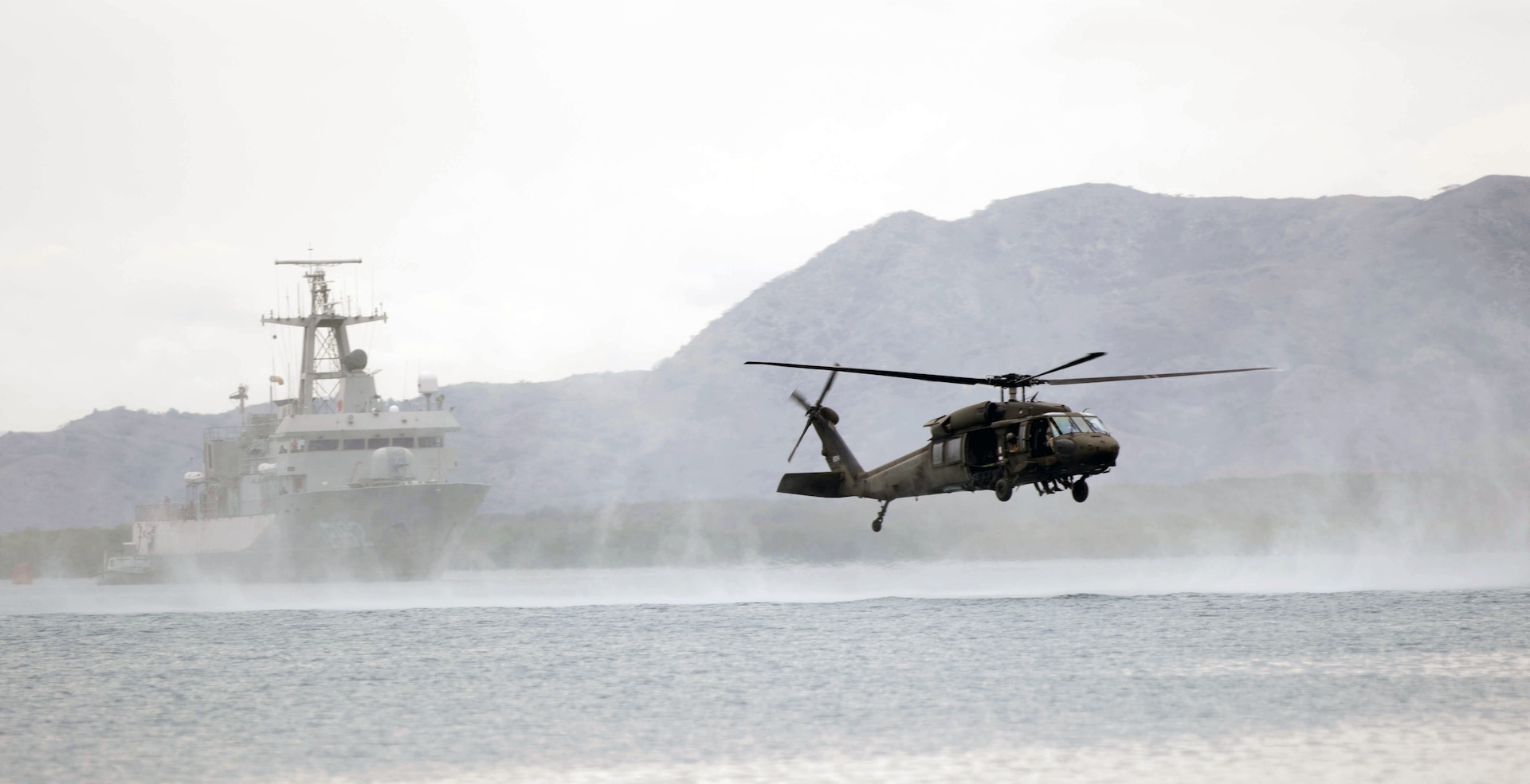A U.S. Army UH-60 Blackhawk hovers over Bahia de Las Calderas.