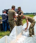 Soldiers are placing sandbags along the Winchester levee system