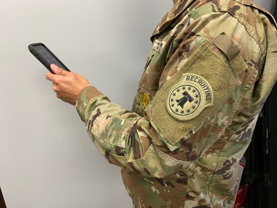 Soldier holding phone.