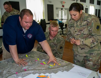 Spec. Jacqueline Herrera, of Cicero, Illinois, and Sgt. Andrew Gray, of Warren, Illinois. Herrera and Gray are among the 10 Soldiers from 2nd Battalion, 123rd Field Artillery Regiment working flood duty in the East Carondelet, Illinois area.