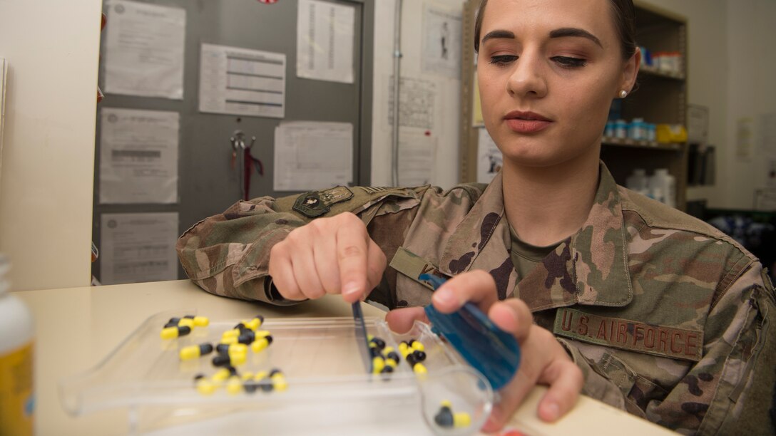 Staff Sgt. Victoria Keyes counts pills in a tray
