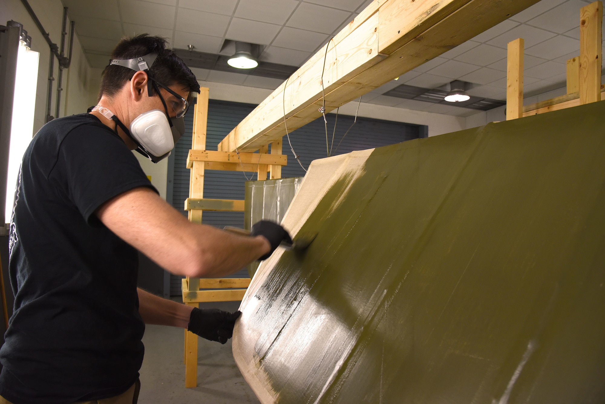 DAYTON, Ohio -- Museum restoration specialist Casey Simmons applies green dope to the Avro 504K control surfaces. This aircraft was originally built in 1966 by the Royal Canadian Air Force's Aircraft Maintenance & Development Unit. Preserving the Air Force's proud legacy, the Restoration Division restores aircraft and aerospace vehicles to historically accurate and visually striking levels. (U.S. Air Force photo by Ken LaRock)