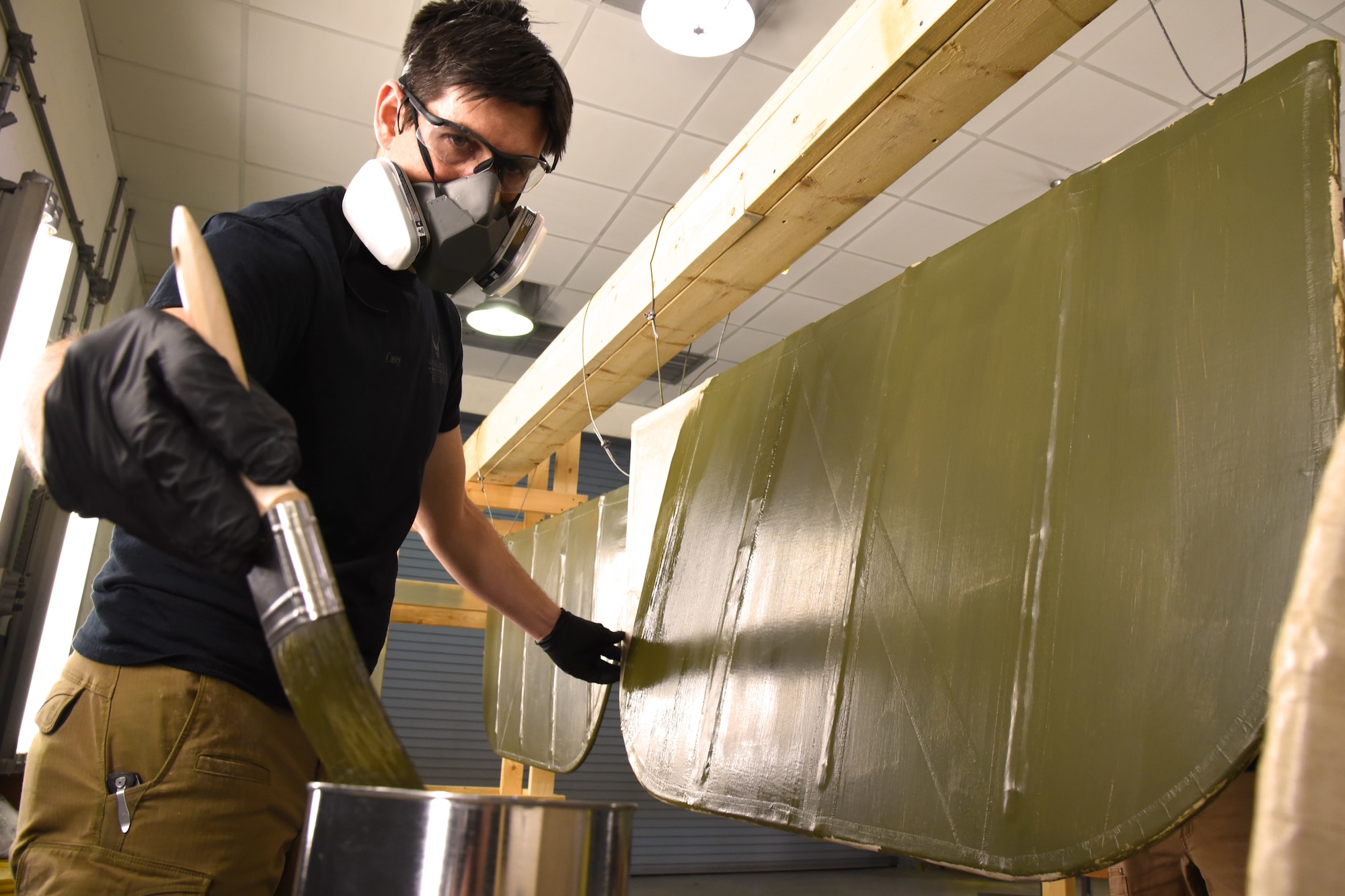 DAYTON, Ohio -- Museum restoration specialist Casey Simmons applies green dope to the Avro 504K control surfaces. This aircraft was originally built in 1966 by the Royal Canadian Air Force's Aircraft Maintenance & Development Unit. Preserving the Air Force's proud legacy, the Restoration Division restores aircraft and aerospace vehicles to historically accurate and visually striking levels. (U.S. Air Force photo by Ken LaRock)