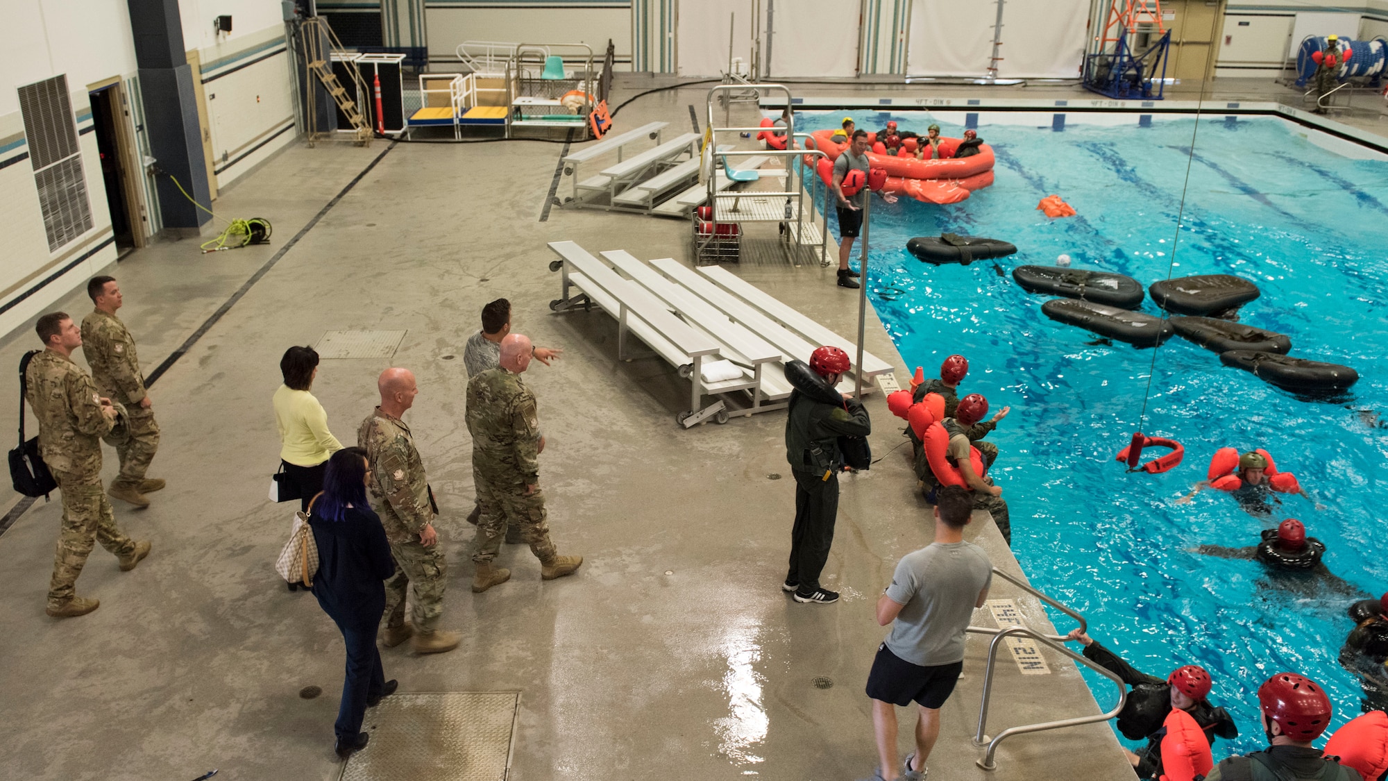 Maj. Gen. Sam Barrett, 18th Air Force commander, Chief Master Sgt. Chris Simpson, 18th AF command chief, and their spouses Kelly Barrett and Trish Simpson, visit the Survival Evasion Resistance Escape School’s water survival training facility during a base visit May 21, 2019 at Fairchild Air Force Base, Washington. SERE trainers and students displayed their specialized training and discussed current mission objectives. (U.S. Air Force photo by Senior Airman Ryan Lackey)