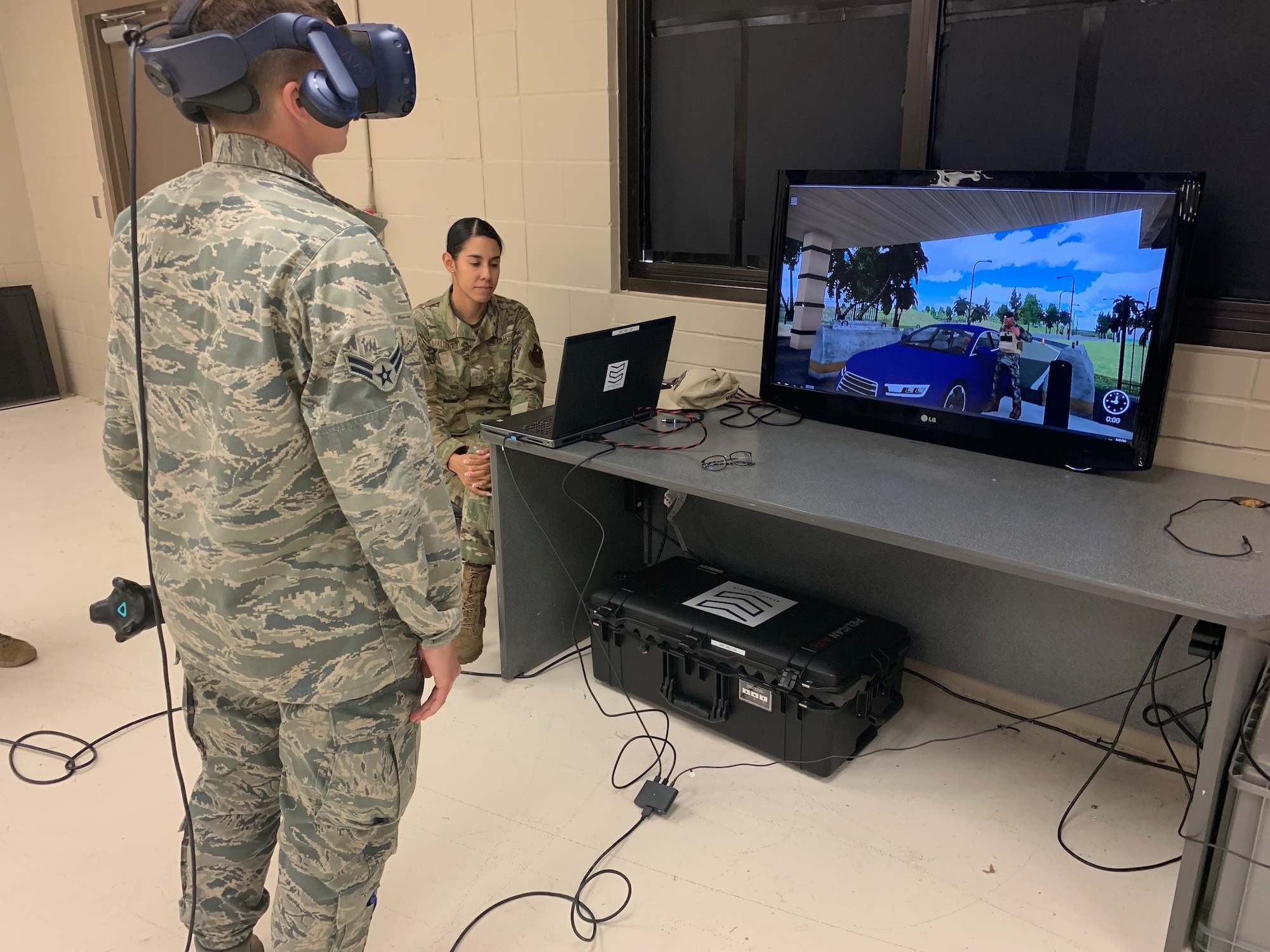 Airman 1st Class Taylor Waldron, a recent graduate of the Security Forces apprentice course, participates in a use of force training scenario in virtual reality environment simulator as Staff Sgt. Marcia Maldonado, 343rd Training Squadron instructor, facilitates training at Joint Base San Antonio-Lackland, Texas,May 29, 2019. The 343rd Training Squadron has added the VR training simulators as part of a beta-test in conjunction with a civilian vendor at no cost to the unit through a partnership with AFWERX.  (U.S. Air Force photo by Dan Hawkins)