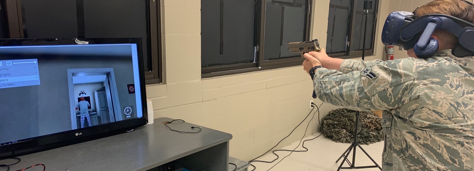 Airman 1st Class Taylor Waldron, a recent graduate of the Security Forces apprentice course, participates in a use of force training scenario in a virtual reality environment simulator at Joint Base San Antonio-Lackland, Texas, May 29, 2019. The 343rd Training Squadron has added the VR training simulators as part of a beta-test in conjunction with a civilian vendor at no cost to the unit through a partnership with AFWERX.  (U.S. Air Force photo bu Dan Hawkins)