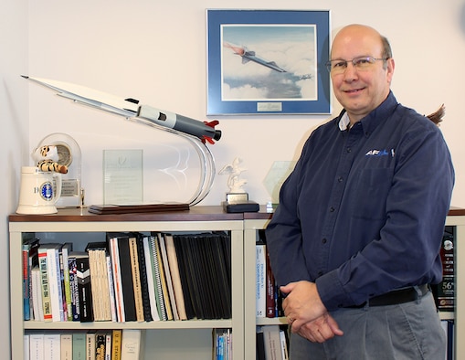 Glenn Liston, chief of the U.S. Air Force Research Laboratory High Speed Experimentation Branch at Arnold Air Force Base, stands by a model of the X-51A WaveRider, an experimental, scramjet-powered hypersonic vehicle. In addition to his other career milestones, Liston said he is most proud of his involvement in the development of the aircraft. He will be retiring from Air Force civilian service June 30 after 37 years of federal service. (U.S. Air Force photo by Deidre Ortiz)