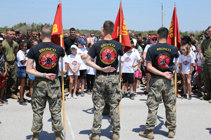 U.S. Marines with 2nd Transportation Battalion, Combat Logistics Regiment 2, 2nd Marine Logistics Group, present the unit’s colors during a Commander’s Cup event at Camp Lejeune, North Carolina, May 24, 2019. The unit adopted Parkwood Elementary in January 2019 School and are volunteering their time with students weekly. (U.S. Marine Corps photo by Cpl. Ashley Lawson)