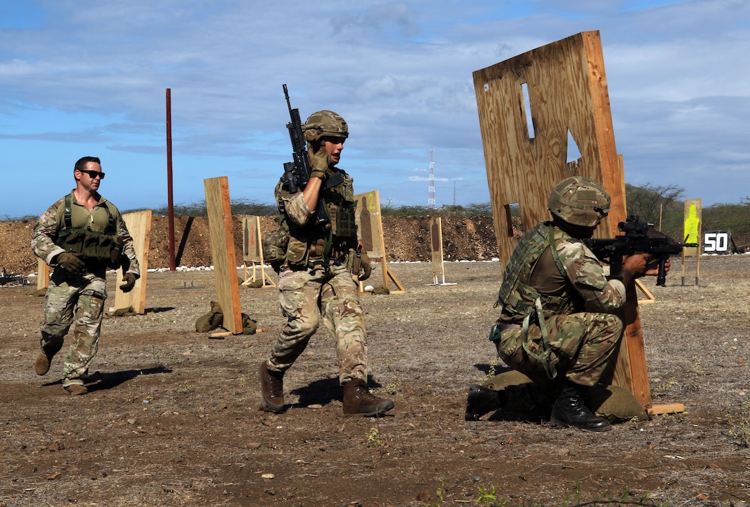 A U.S. Soldier coaches members of the 24th Commando Royal Engineers during weapons training.