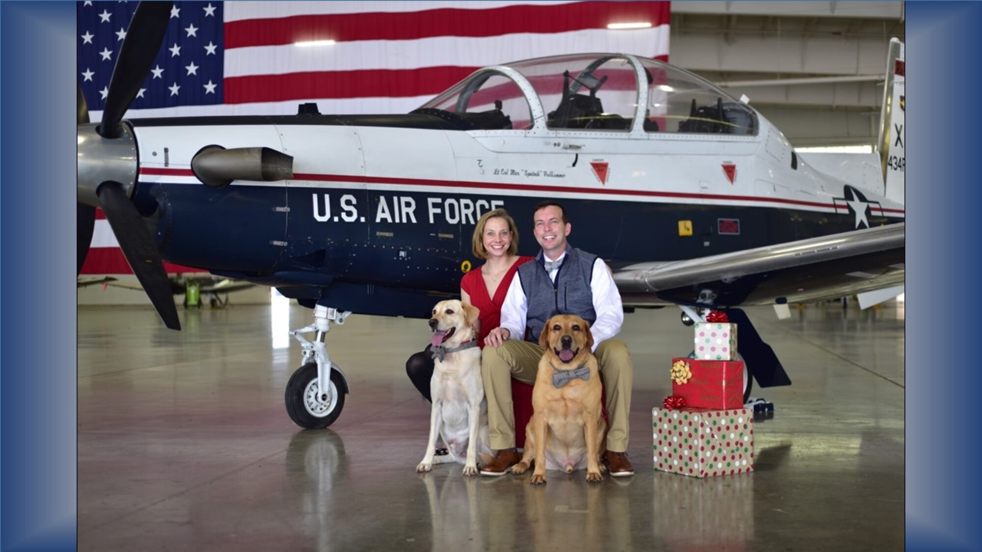 Air Force Reserve Citizen Airman Maj. Hilary Foley, 96th Flying Training Squadron T-1 Jayhawk instructor pilot, Laughlin Air Force Base, Texas, poses for a holiday family portrait with her husband, 85th Flying Training Squadron Commander Lt. Col. Bryan Foley, and their yellow lab “kids,” Weston and Chase. As a former active duty C-5 pilot, current Reserve instructor pilot and wife of an active duty squadron commander, Major Foley has the perfect experience and background to help “bridge the gap” between active and Reserve teammates and families. (Courtesy photo)