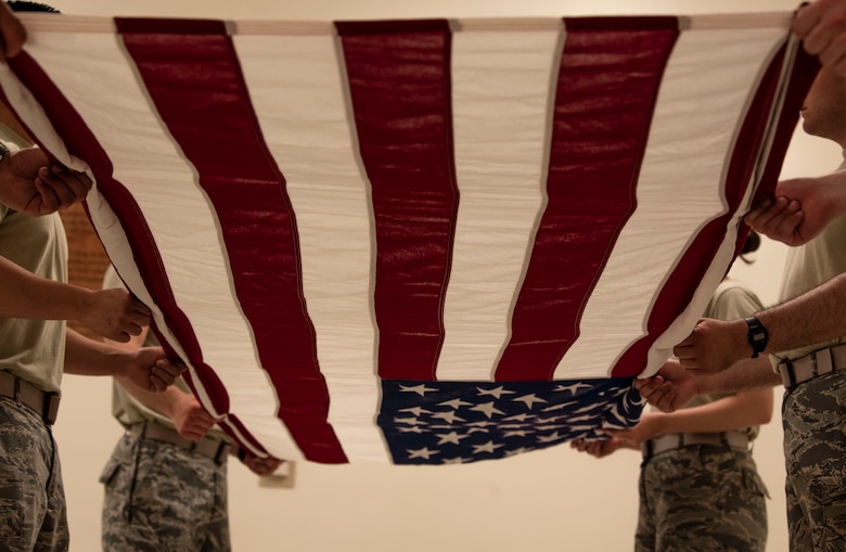 Team Shaw Airmen practice a six-man flag folding sequence at Shaw Air Force Base, S.C., May 21, 2019.