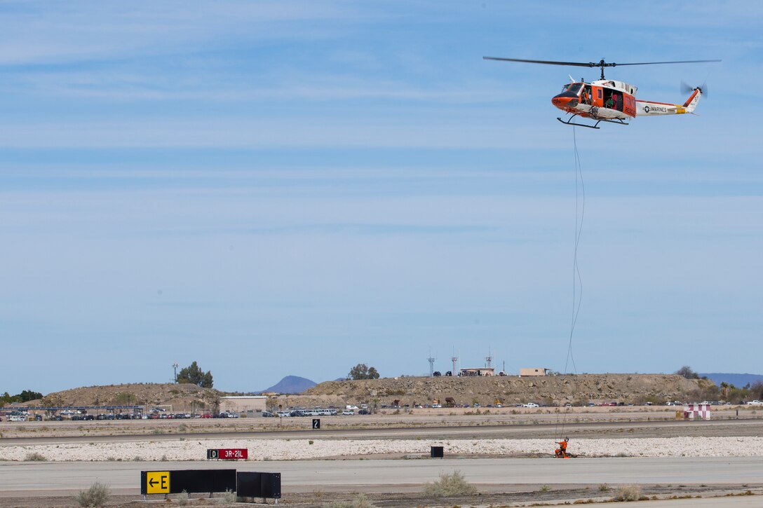 Marine Corps Air Station(MCAS) Yuma, Ariz., Search and Rescue HH-1N "Huey" displays their capabilities during the 2019 Yuma Airshow Saturday March 9, 2019. The "Huey" is used by the Marine Corps to provide all-weather, day-or-night, airborne command, control and coordination for assault support operations. Additionally, it is used for assault transportation and maritime special operations, forward air control, aeromedical evacuation of causualties from the field and tactical recovery of aircraft and personnel missions. The airshow is MCAS Yuma's only military airshow of the year and provides the community an opportunity to see thrilling aerial and ground performers for free while interacting with Marines and Sailors. (U.S. Marine Corps photo by Pfc. John Hall)