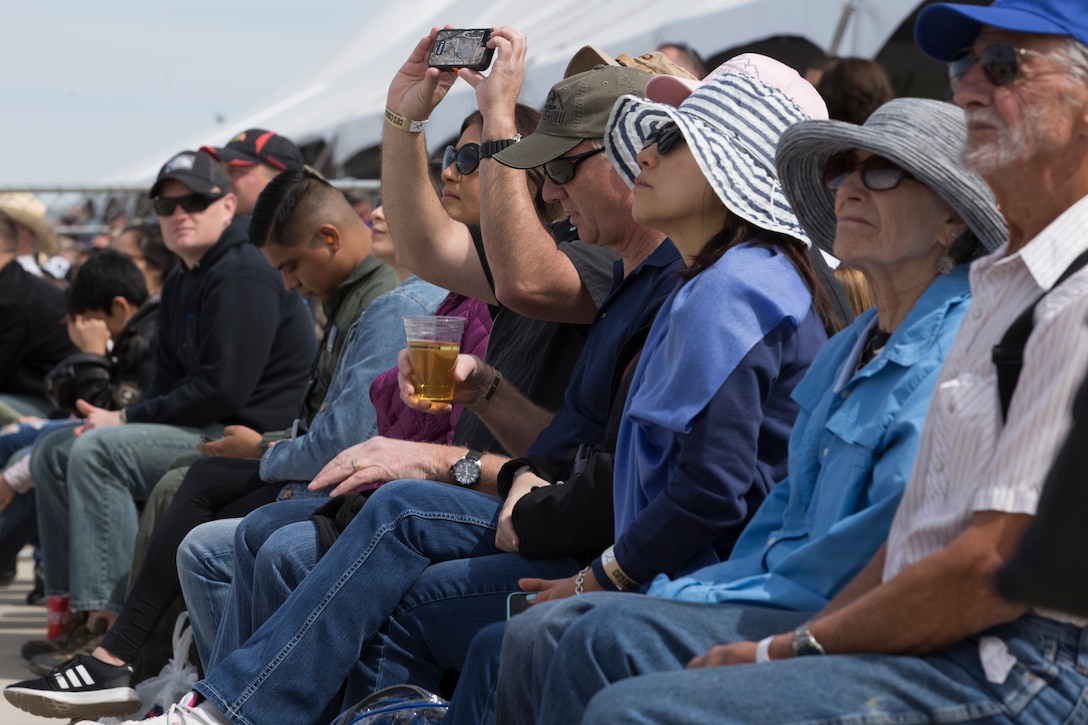 Spectators at the 2019 Yuma Airshow watch aerial demonstrations conducted by airshow performers at Marine Corps Air Station(MCAS) Yuma, Ariz., Saturday March 18, 2019. The airshow is MCAS Yuma's only military airshow of the year and provides the community an opportunity to see thrilling aerial and ground perfromers for free while interacting with Marines and Sailors. (U.S. Marine Corps photo by Pfc. John Hall)