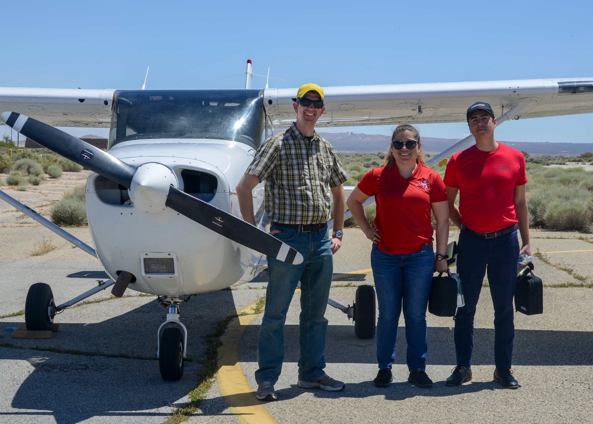 Chris Liebmann, 773rd Test Squadron, Aero Club pilot, Chloe Angulo, 771st TS, and David Cortes, 775th TS, pose for a photo with a Cessna 172 airplane following their inaugural Airmanship flight at the Aero Club on Edwards Air Force Base, Calif., May 24. (U.S. Air Force photo by Giancarlo Casem)